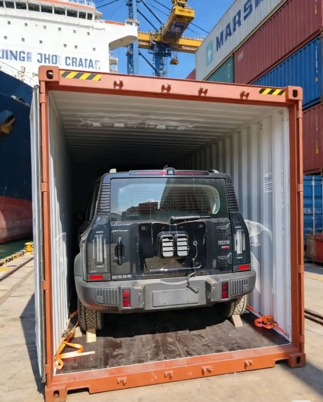 SUV lashed inside a 40HQ shipping container for vehicle export